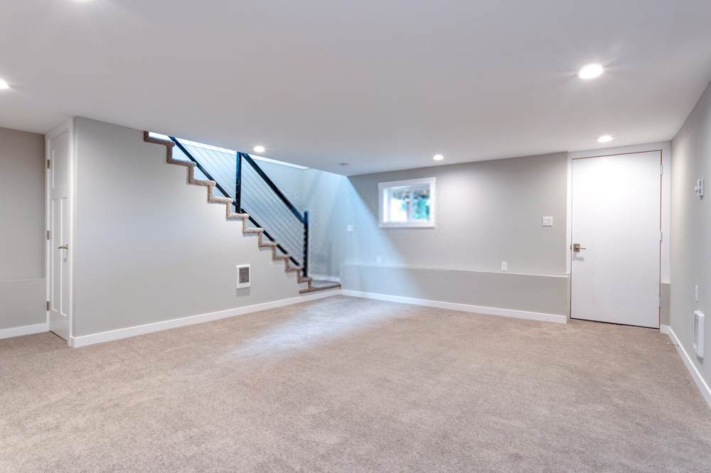 basement finishing with carpet and grey tones