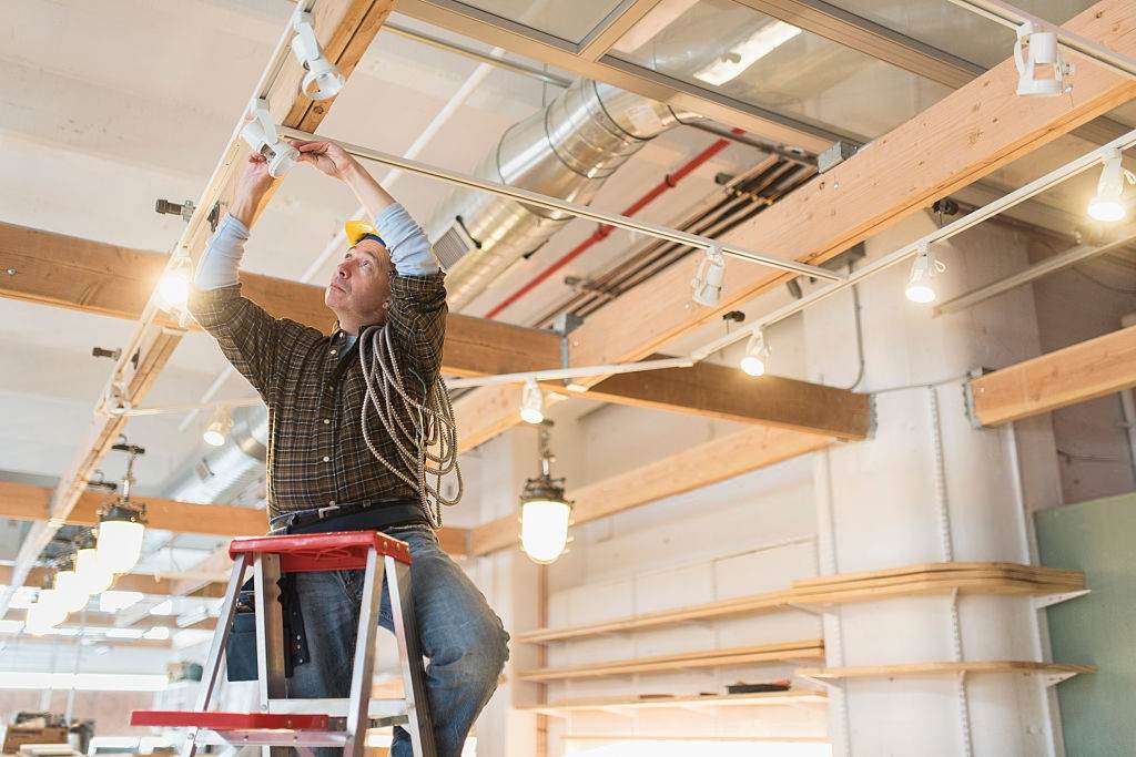 electrician installing track lighting